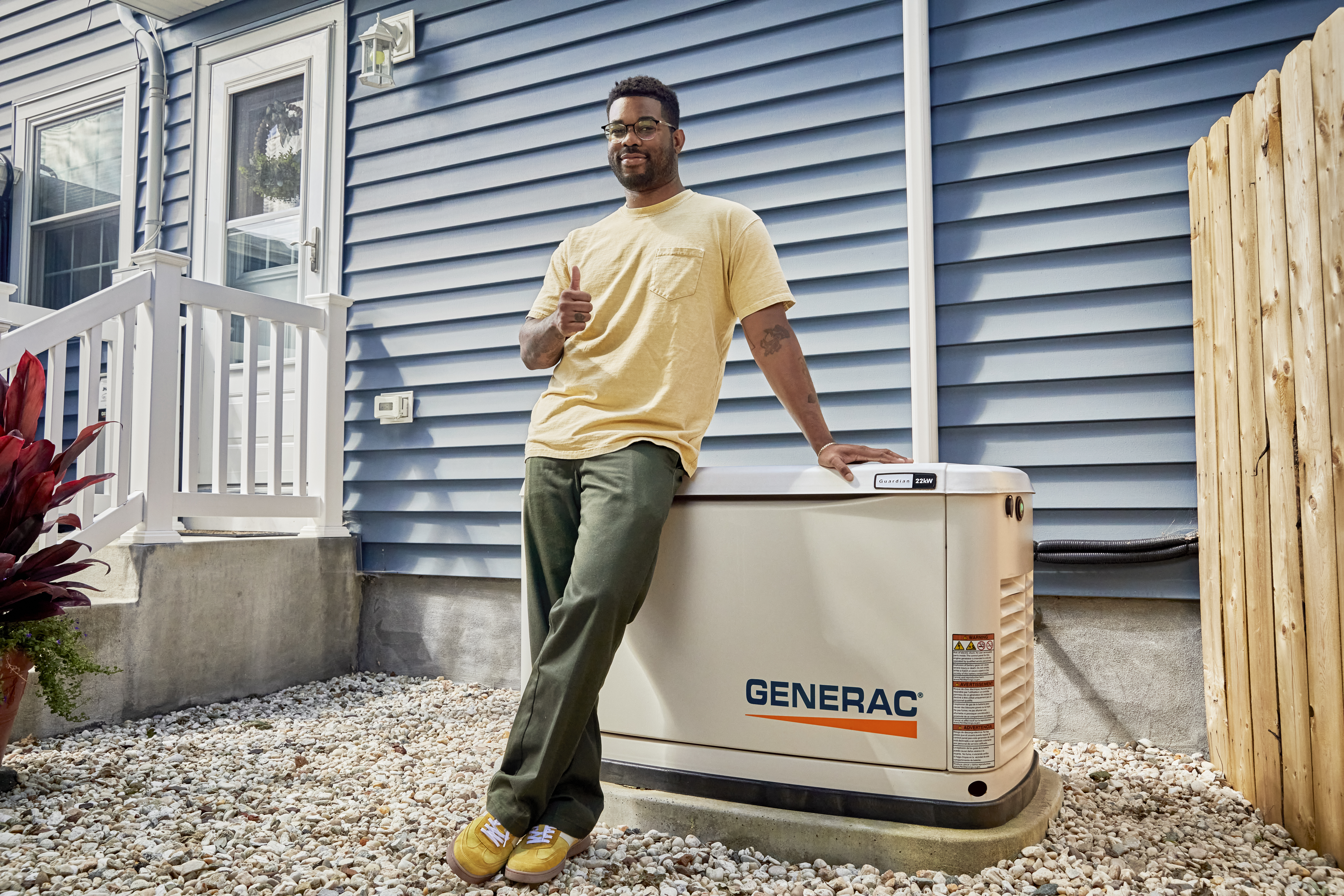 Generac generator being set up by an expert installer in a Cape Cod homeowner's backyard